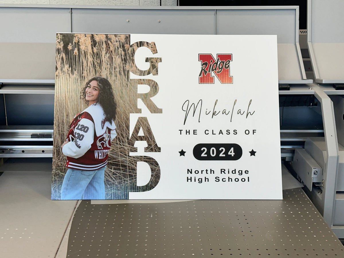 Personalized graduation yard sign with a student portrait and Class of 2024 lettering.
