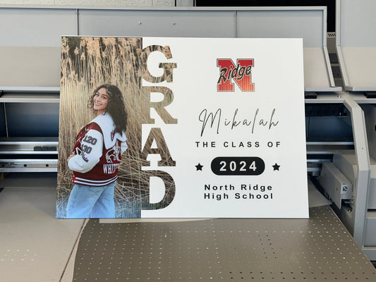 Personalized graduation yard sign with a student portrait and Class of 2024 lettering.