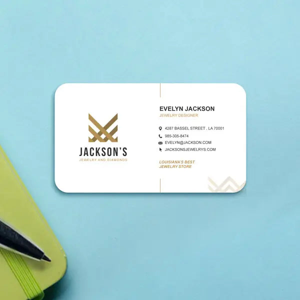 White rounded-corner business card with gold branding on a blue surface.